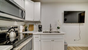 A modern kitchen with white cabinets, a stainless steel stove, a microwave, and a built-in oven. - 10 Mi to Riverside! Apt Near Ruhs Medical Center (Moreno Valley)
