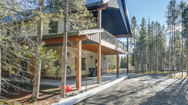 A two-story building with a covered porch and a solar panel on the roof. - Gateway to Yellowstone! Modern Island Park Cabin (Island Park)