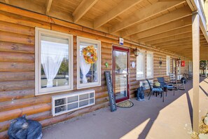 A wooden cabin with a porch, a welcome sign, and outdoor seating. - Stay By the Blue Ridge Parkway! Cozy Mtn Condo (Fancy Gap)