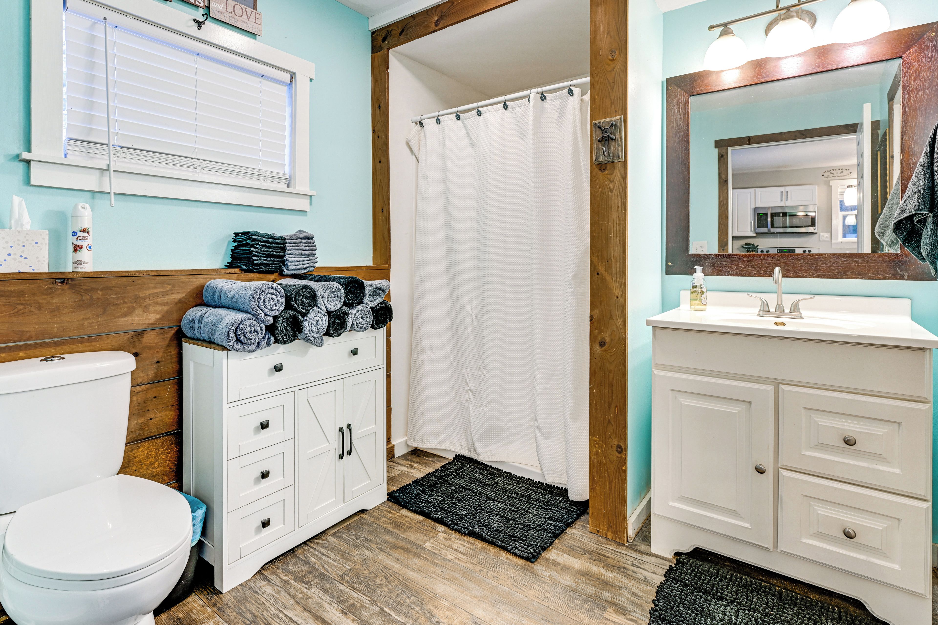 A bathroom with a toilet, a sink, and a shower curtain.