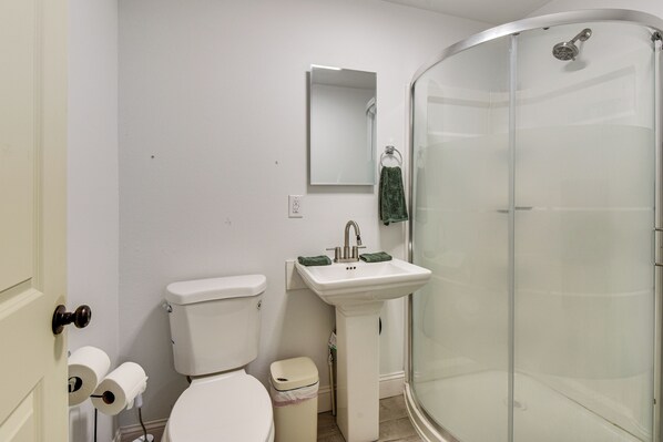 A bathroom with a toilet, sink, and glass-enclosed shower. - Hike & Sip in North Georgia: Apartment w/ Deck (Alto)