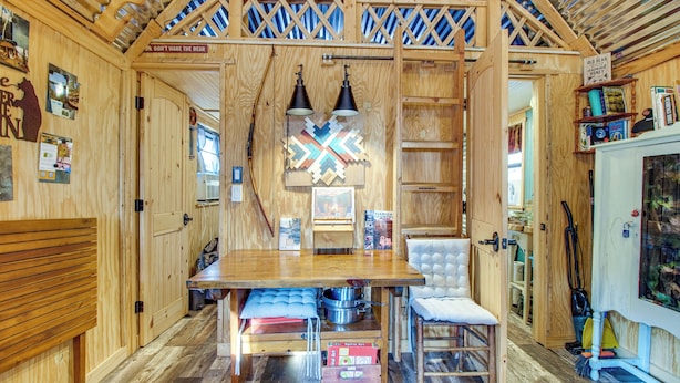 A wooden interior with a dining table, chairs, and a kitchen area. - Hike the Ouachitas! Remote Mtn Hideaway w/ Trails (Wister)