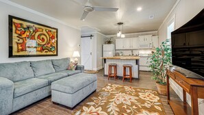 A modern kitchen with white cabinets, a bar area, and a ceiling fan. - Wooded Couples Haven! 15 Mi to Wrightsville Beach (Wilmington)