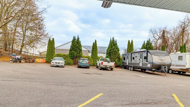 A parking lot with several vehicles, including cars and a trailer. - 4 Mi to Mauch Chunk Lake: Spacious Apt w/ Bar! (Summit Hill)