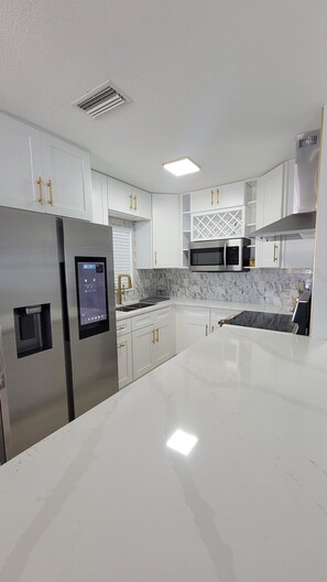 Fridge, microwave, oven, stovetop - Villa Azalea · 4BR Heated Pool · Game Room · Near Gulf Beaches (Seminole)