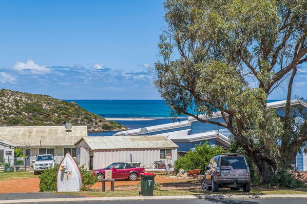 A coastal residential area with houses, a beach, and a clear sky. - Love You Moore-Breathtaking Views of Both Ocean and River. (Guilderton)
