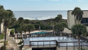 A rooftop pool with a view of the ocean and beach. - Dove's Island Nest - Cozy Condo, Pool, Near Beach, Tennis Courts, Ocean Views (St. Augustine)