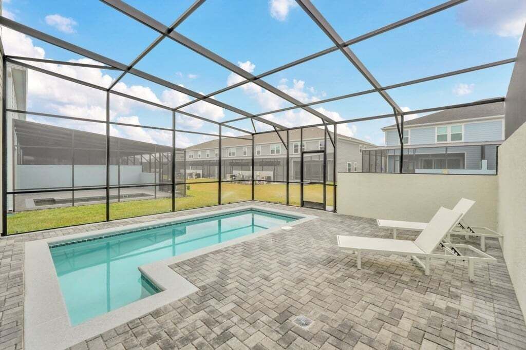 A covered outdoor swimming pool with a view of residential buildings.