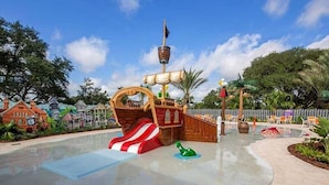 A pirate-themed play area with a slide, a ship-shaped play structure, and a small green sea creature. - 5 Bed Multiple Bunks Perfect For Kids With Pool! 5 Bedroom Townhouse (Davenport)