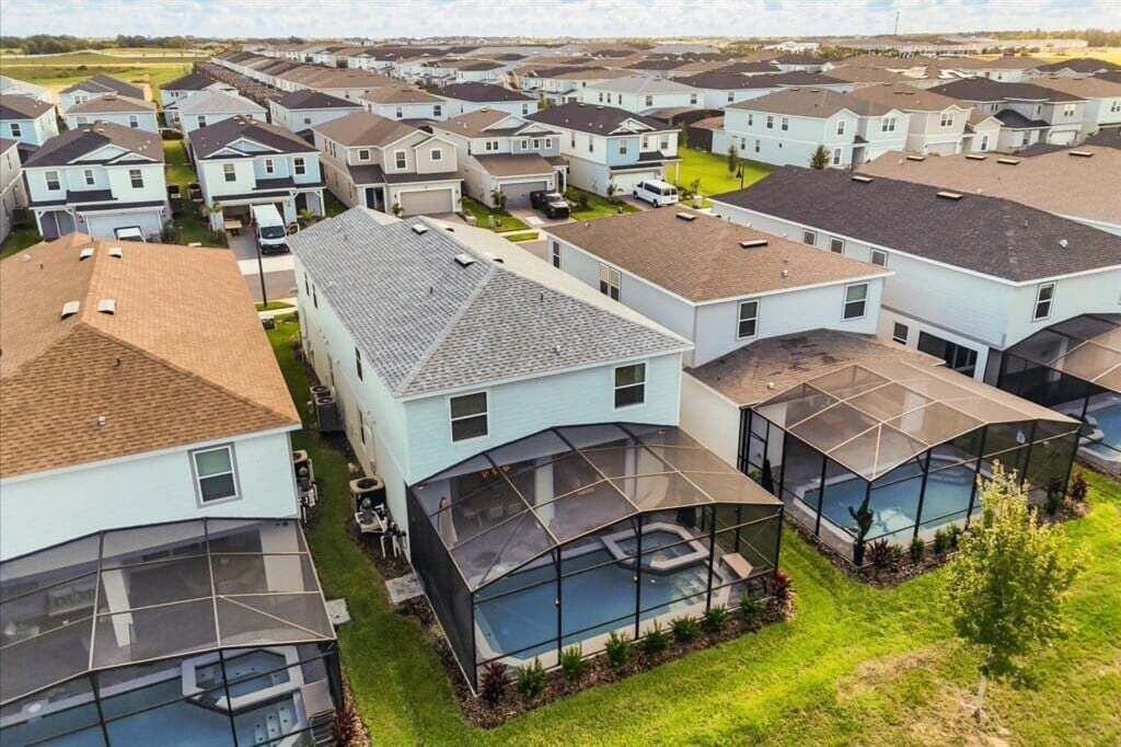 A residential area with modern houses featuring large glass windows and attached garages.