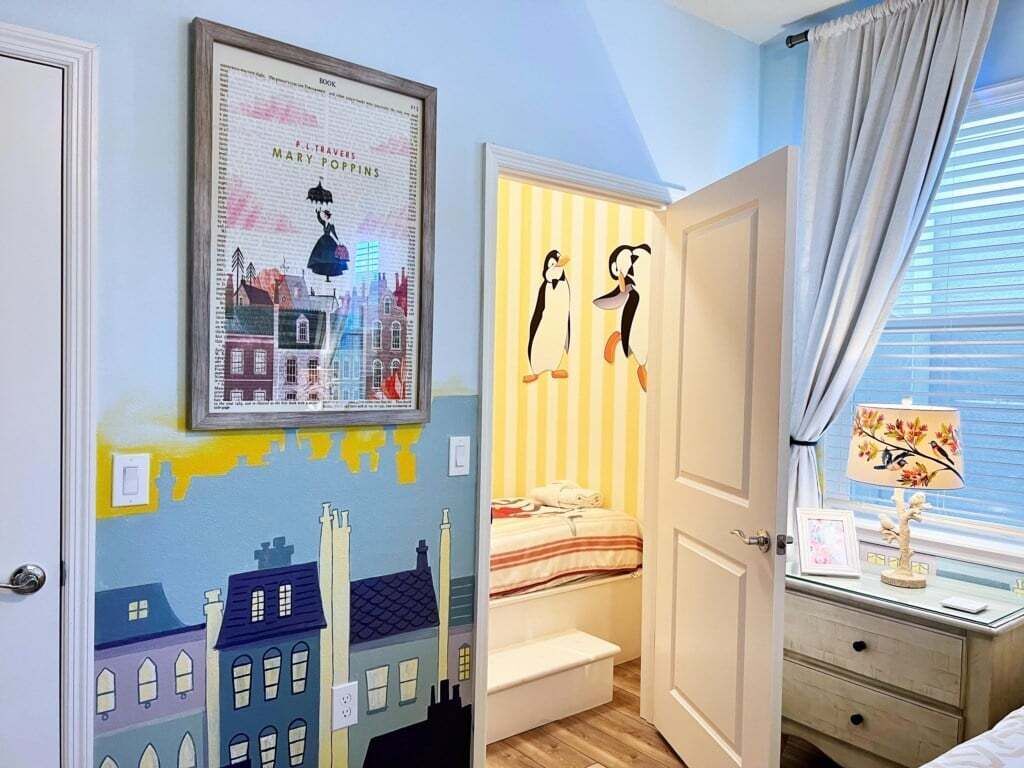 A child's bedroom with a bed, a nightstand, and a window with curtains.