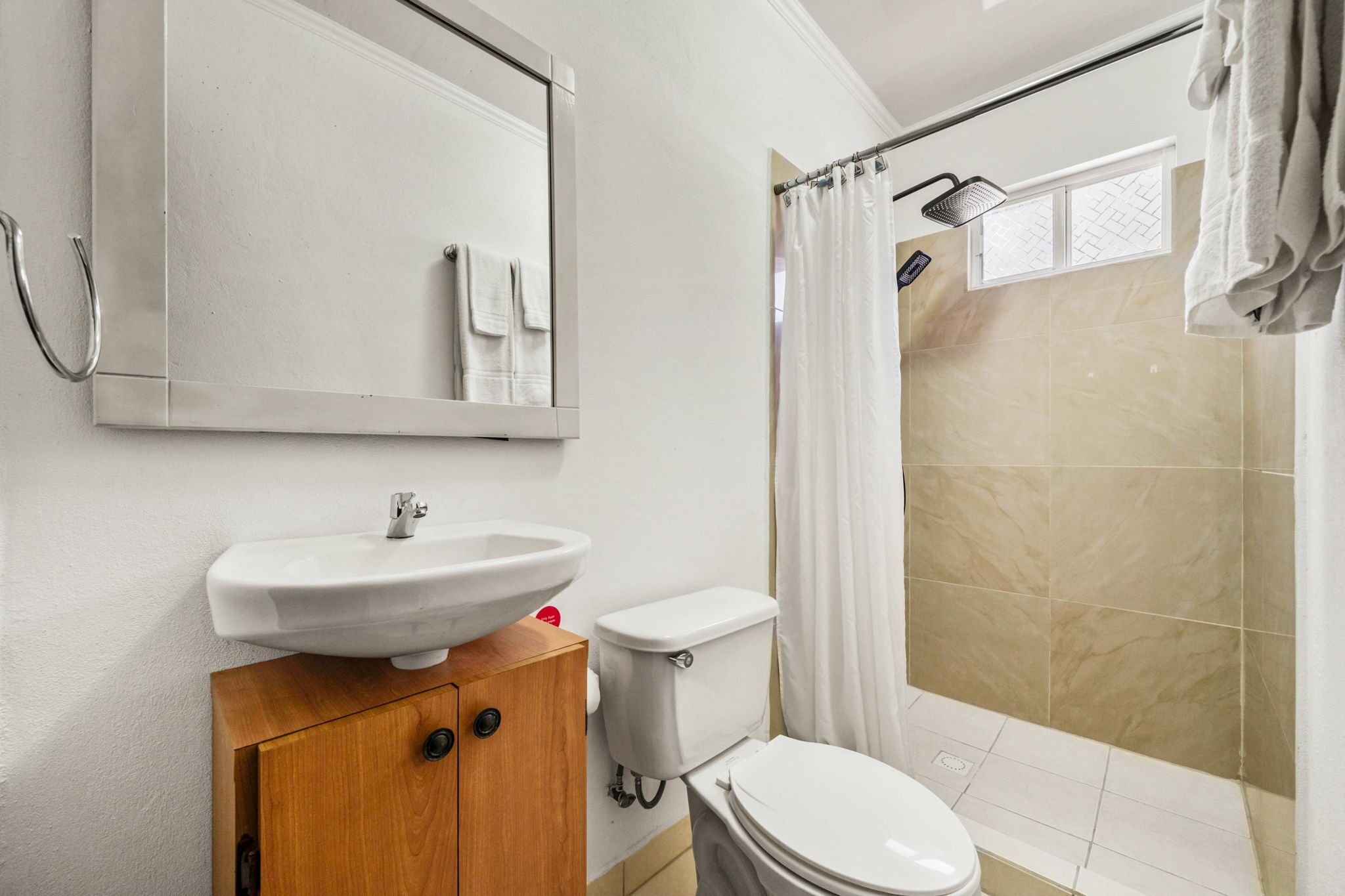 A bathroom with a sink, toilet, and shower.