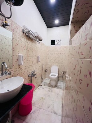 A bathroom with a sink, toilet, and shower. - Hotel Gulmarg Residency (Mount Abu)