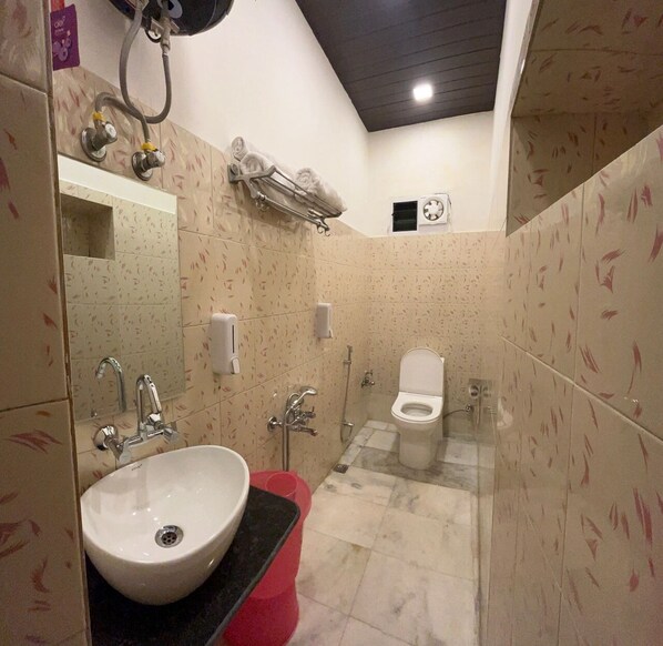 A bathroom with a sink, toilet, and shower. - Hotel Gulmarg Residency (Mount Abu)