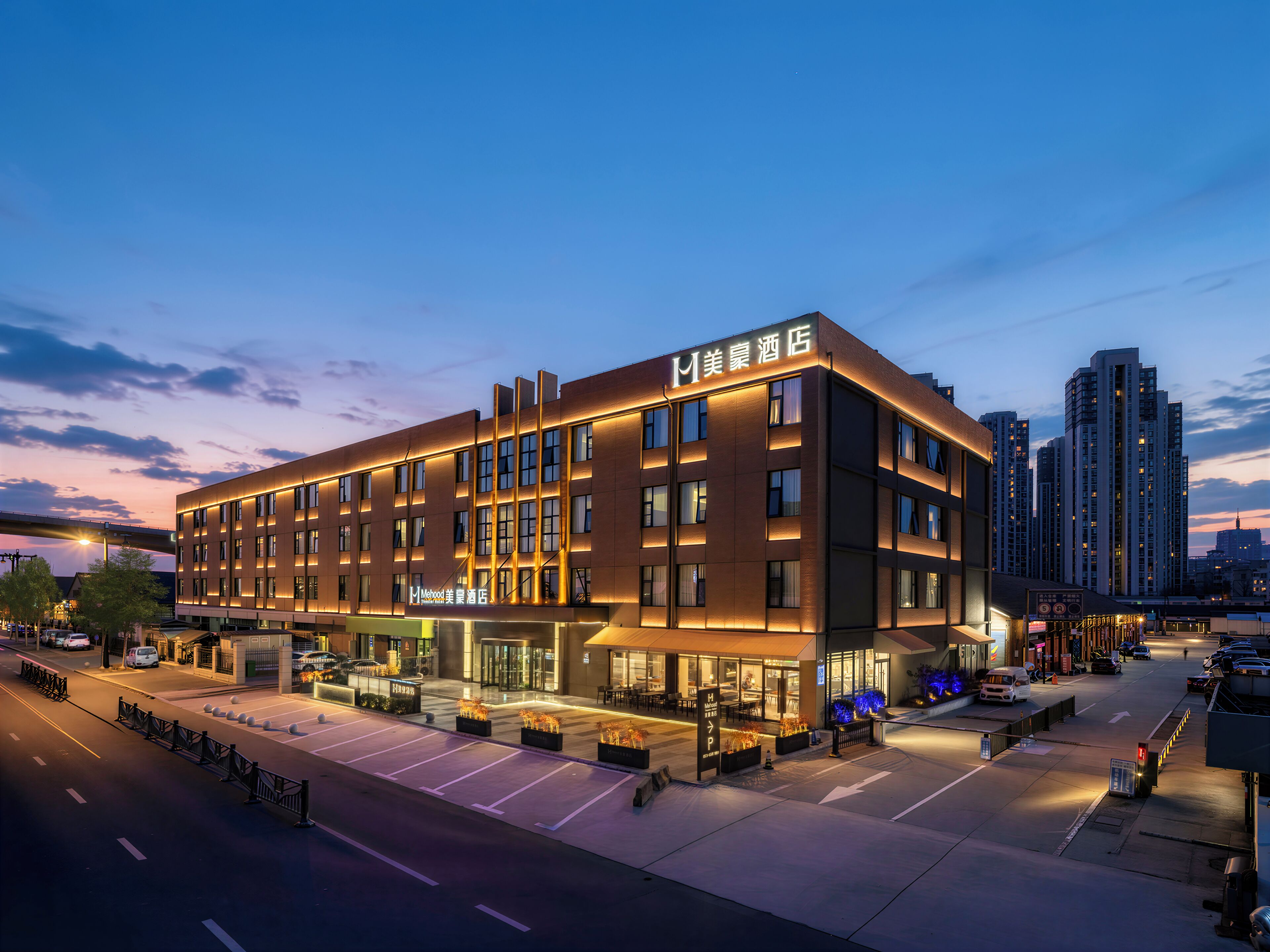 A modern hotel with a flat facade, large windows, and a sign indicating a restaurant on the ground floor.