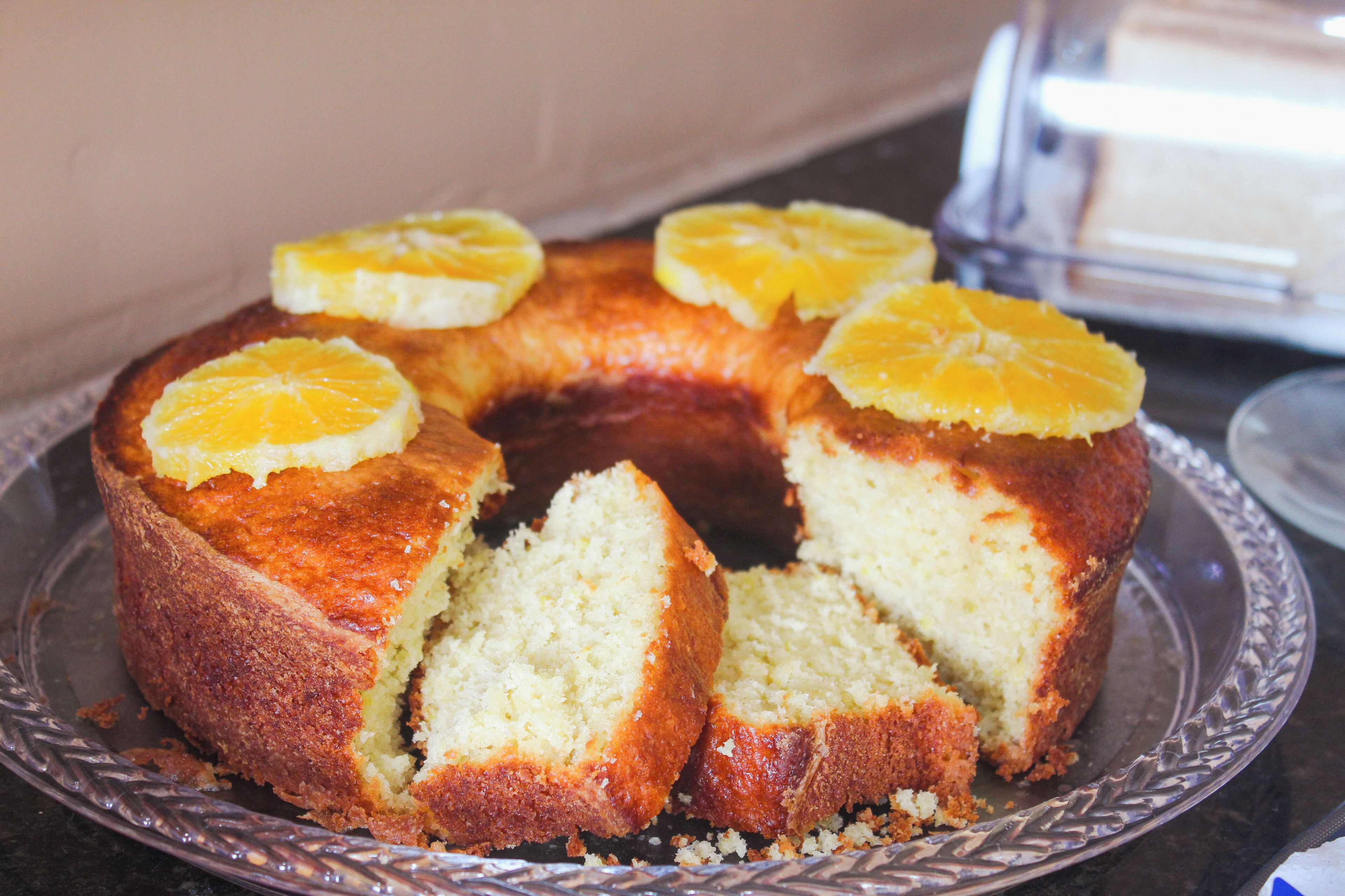 A cake with orange slices on a plate.