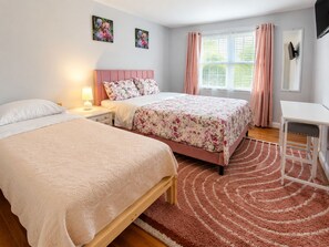 A bedroom with two beds, a desk, and a window with curtains. - Chic Towson Townhome: 3BR, Bonus Suite, Deck, Free Parking - 15 Min to Baltimore (Towson)