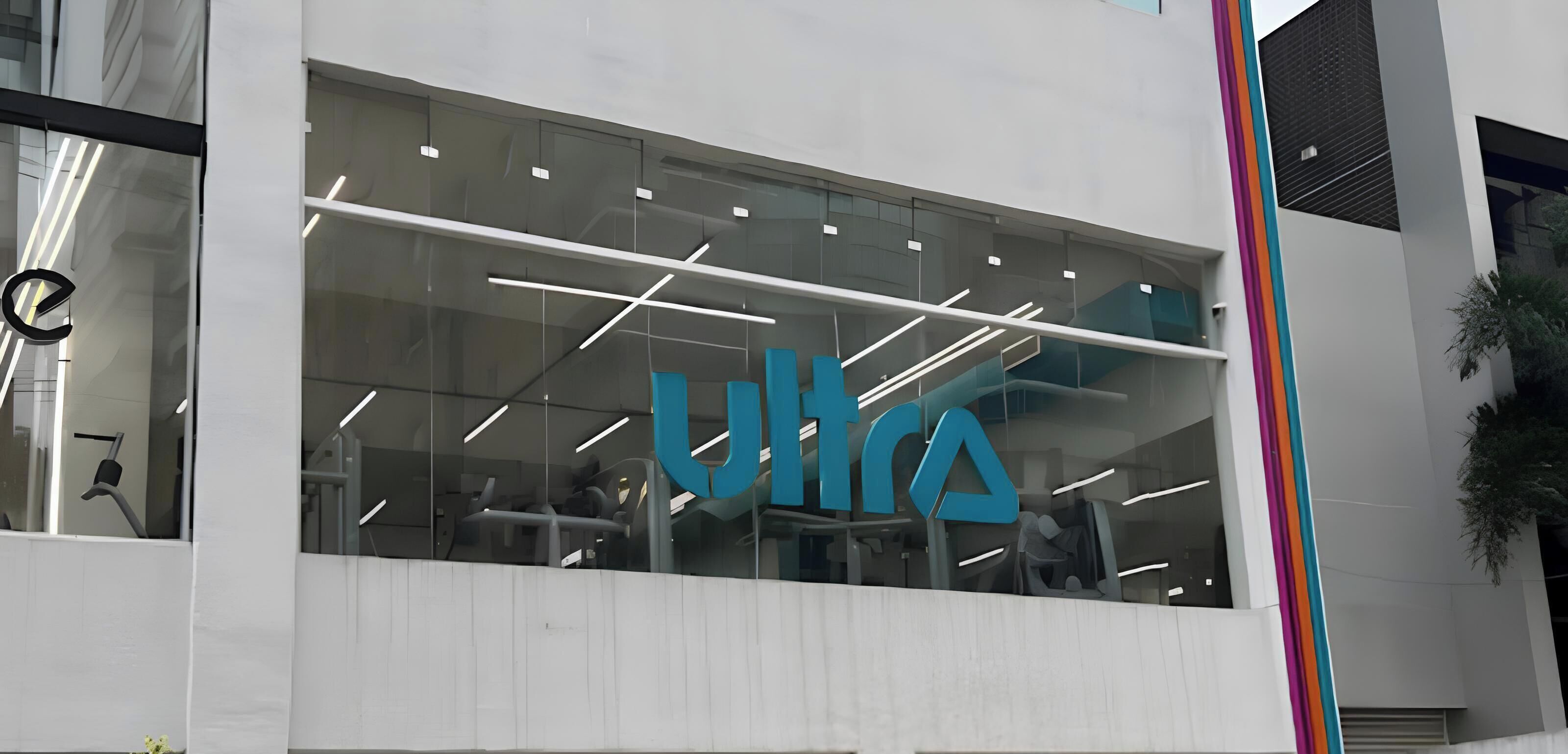 A modern building with a large glass facade and the logo "ULTRA" prominently displayed.