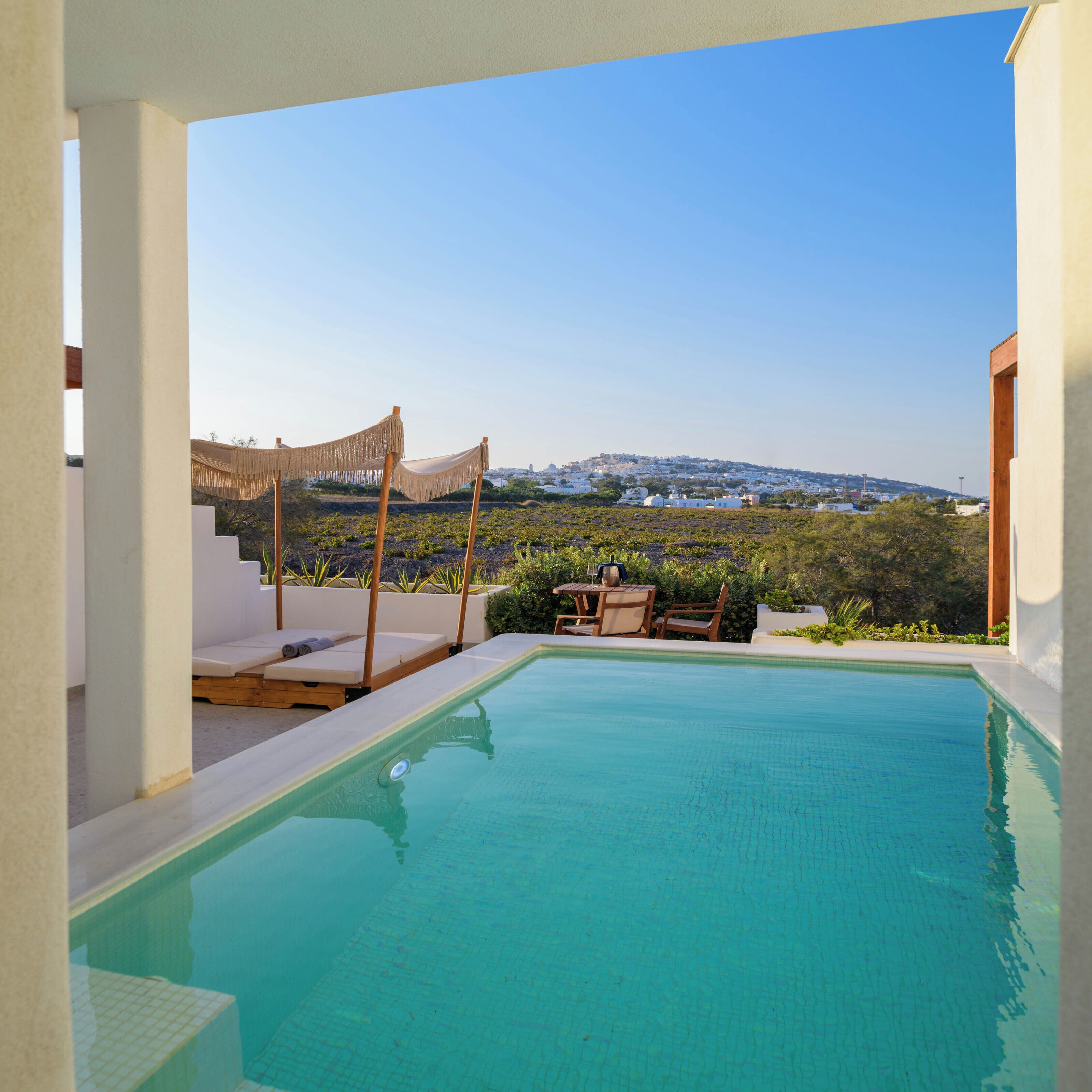 A swimming pool with a view of a hillside town.