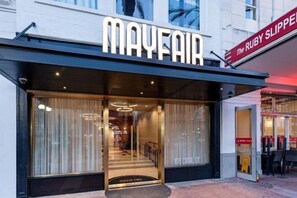 The exterior of Mayfair hotel with a clear entrance and a sign for The Ruby Slipper. - 2BR Iconic Penthouse Living + Private Patio The Mayfair (New Orleans)