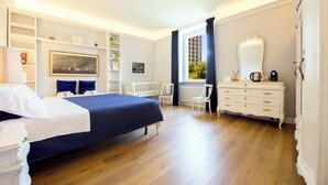 A bedroom with a bed, dresser, chair, and shelves with decorative items. - Mare e Monti (Genoa)