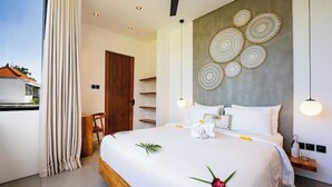 A modern hotel room with a large bed, a wooden headboard, and a view of the outside. - Casa Riva by GORO (Bali)
