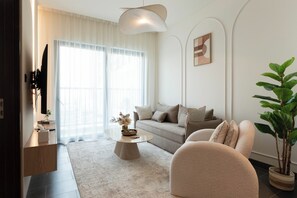 Deluxe Apartment, Balcony, Pool View | Living area | 65-inch Smart TV with digital channels, Netflix, streaming services - Chic 1BR Apartment - The Crest Dubai (Dubai)