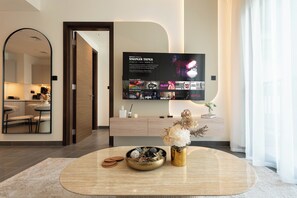 Deluxe Apartment, Balcony, Pool View | Living area | 65-inch Smart TV with digital channels, Netflix, streaming services - Chic 1BR Apartment - The Crest Dubai (Dubai)