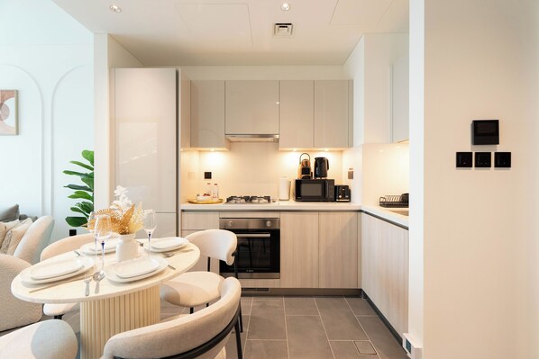 Departamento Deluxe, balcón, vista a la alberca | Cocina privada | Refrigerador, microondas, horno y parrilla de estufa 