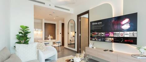 Deluxe Apartment, Balcony, Pool View | Living area | 65-inch Smart TV with digital channels, Netflix, streaming services