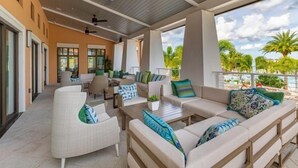 A covered outdoor seating area with sofas and chairs, a coffee table, and ceiling fans. - 7‑BR w/ Private Pool & Game Room (Kissimmee)