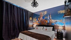 A bedroom with a large bed, dark curtains, a nightstand with a lamp, and a wall mural of a castle. - Themed 5BR Home + Pool at Windsor Cay (Clermont)
