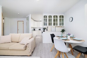 Basic Apartment | Living area | 55-inch flat-screen TV with cable channels