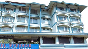 A multi-story hotel with a classic architectural style, featuring balconies and large windows. - Hotel Windsor (Patna)