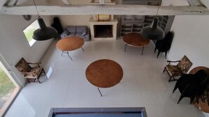 A spacious room with a high ceiling, a billiards table, and several seating areas with sofas and chairs. - Chambres Domaine de Saint Marc (Saint-Médard)