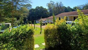 A residential area with houses, a parked truck, and a car. - Riverside Villas Nanyuki (Nanyuki)