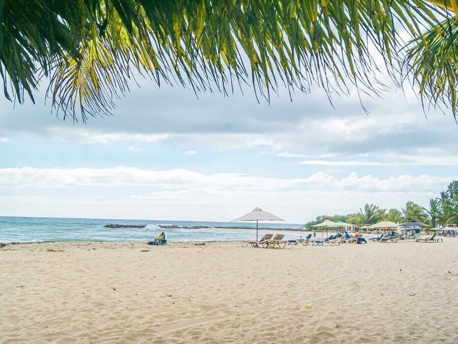 On the beach, white sand, free beach cabanas, beach umbrellas