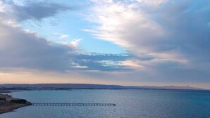 A coastal view with a pier extending into calm waters under a partly cloudy sky. - Casablanca resort Hurghada Red Sea (Hurghada)