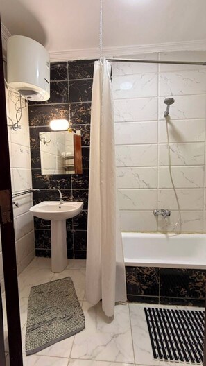A bathroom with a white sink, a bathtub, and a shower. - Casablanca resort Hurghada Red Sea (Hurghada)