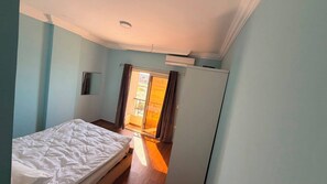 A bedroom with a bed, a wardrobe, and a sliding glass door leading to an outdoor area. - Casablanca resort Hurghada Red Sea (Hurghada)