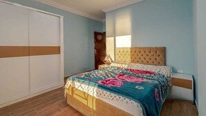 A bedroom with a bed, a wardrobe, and a nightstand. - Casablanca resort Hurghada Red Sea (Hurghada)