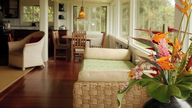 A cozy living room with a sofa, chairs, and a dining area.