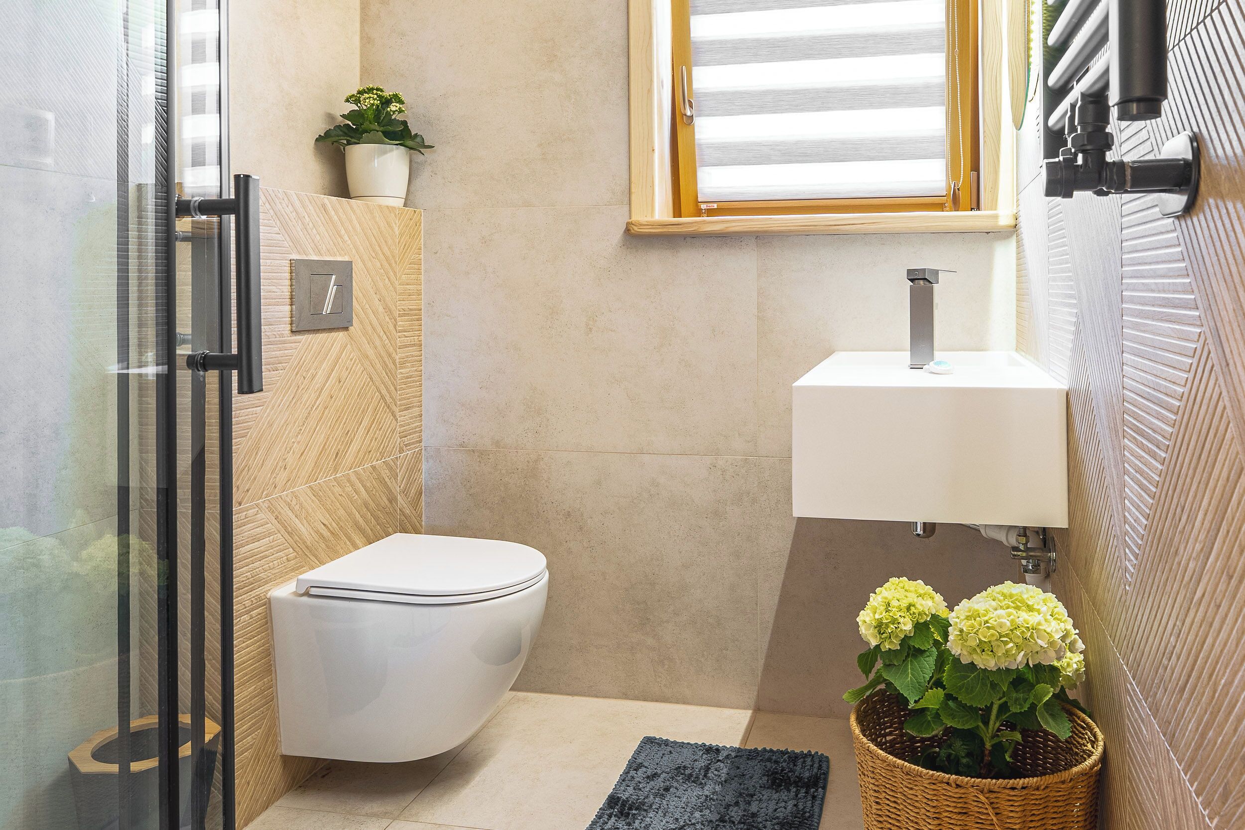 A modern bathroom with a toilet, sink, and shower area.