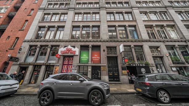 A multi-story building with a mix of commercial spaces, including a massage and spa, a tattoo parlor, and a restaurant. - Host Stay Apartment 5 Stanley Street (Liverpool)