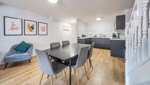 A modern kitchen with dark cabinets and a marble backsplash. - Host Stay Apartment 8 Stanley Street (Liverpool)