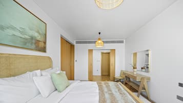 A modern bedroom with a bed, bedside table, and a large mirror.