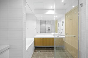 A modern bathroom with a glass shower enclosure, a wooden vanity, and a large mirror. - 1011 Bloomfields1BR Al Nada Raha Beach (Madinat Zayed)