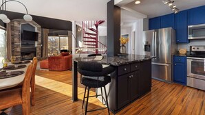 A modern kitchen with a central island, stainless steel appliances, and blue cabinets. - Mars Hill Retreat: Sauna, Wet Bar, Hot Tub, Views (Mars Hill)