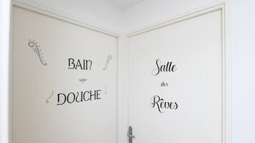A door with French text indicating 'Bain Douche' and 'Salle des Réveils'.