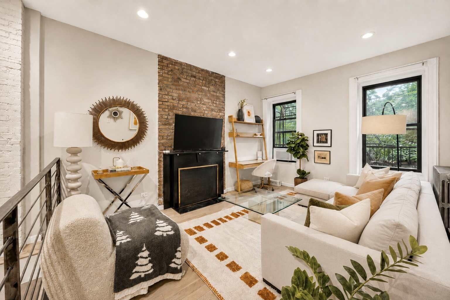 A modern living room with a fireplace, a television, a sofa, and a coffee table.